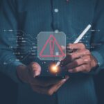 Smartphone displaying incoming call 8888996650 beside laptop showing newznav.com website in a cyber safety themed setup