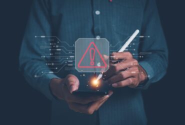 Smartphone displaying incoming call 8888996650 beside laptop showing newznav.com website in a cyber safety themed setup